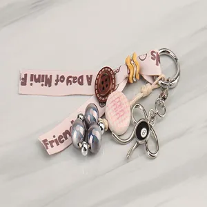 Creative DIY keychain with printed ribbon, wooden button, beads and 8-ball pendant detail.