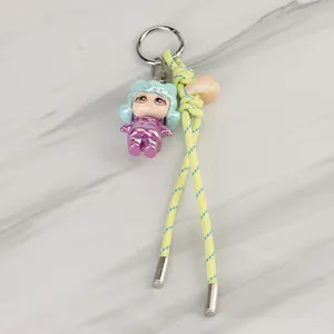 Woven keychain lanyard with cute doll pendant, stylish bag charm and accessories for daily use.