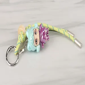 Detailed view of the colorful braided keychain lanyard with cute doll and metal ring.