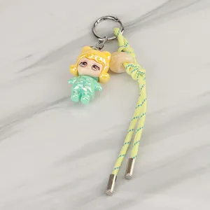 Cute cartoon doll keychain with braided rope, stylish backpack charm and bag accessory.