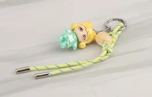 Detailed view of colorful braided keychain strap featuring cute doll charm and metal ring for DIY use.