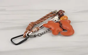 Detailed shot of a colorful braided leather keychain charm with metal clasp and decorative beads.