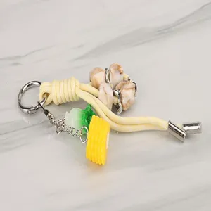 Close-up of the short braided keychain lanyard with cute corn charm and stone beads.