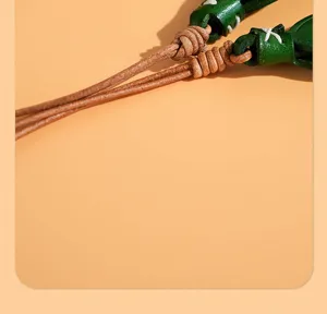 Close-up detail of vegetable-tanned leather tulip pendant for car mirror or bag charm decoration.