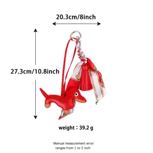 Cute red leather dachshund bag charm with floral silk scarf and tassel pendant accessory.