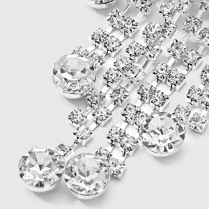 Rhinestone crystal tassel detail shot, sparkling diamonds for elegant clothing decoration.