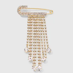 Rhinestone safety pin detail showcasing shimmering crystal tassels and gold-tone metal finish.