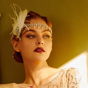 Vintage 1920s Gatsby feather rhinestone headband party hair accessory for women main view.