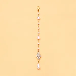 Exquisite Indian style pearl forehead chain detail, golden rhinestone maang tikka for bridal.