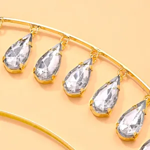 Close-up detail of the golden rhinestone teardrop halo headband, exquisite crystal drops.