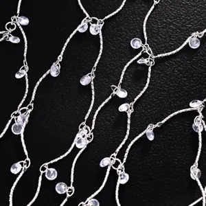 Exquisite silver rhinestone chain headpiece detail, sparkling crystal droplet hair accessory.
