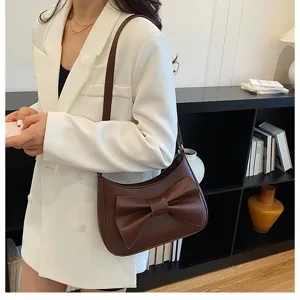 Chic brown leather shoulder bag with a stylish bow detail, perfect for casual daily commute.