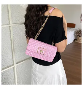Pink quilted shoulder bag featuring glossy finish, elegant gold chain strap and metal clasp.