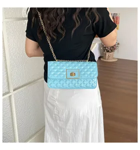 Light blue quilted chain shoulder bag detail showing metallic lock and stylish design.