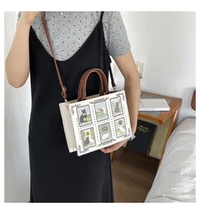 Detailed view of the vintage cat tarot card tote bag with brown leather handles and chic design.