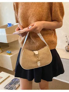 Detailed view of stylish woven straw shoulder bag underarm bag with white trim for women.