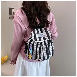 Black and white striped backpack with bow pattern, casual campus school bag for women daily commute.
