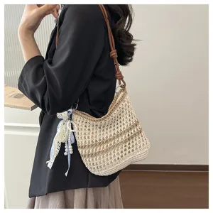 Handmade knitted straw shoulder bag for women, stylish mini crossbody bag for summer beach.