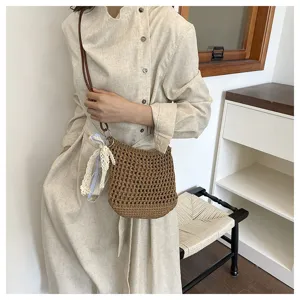 Close-up view of the handmade brown crochet crossbody bag showcasing detailed knit texture.