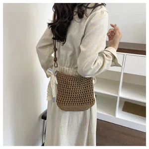 Detail shot of a trendy handmade crochet crossbody knit phone bag with delicate strap ornament.