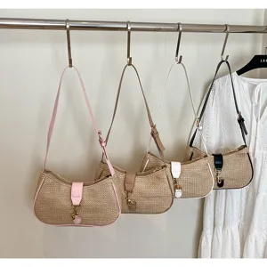 Woven straw shoulder bag, crescent hobo bag with metal lock and stylish contrast strap detail.