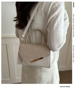 Elegant sequin evening handbag with top handle and shoulder strap for women trendy design.