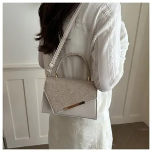 Elegant sequin evening shoulder bag with chic flap design and metal accent for women.
