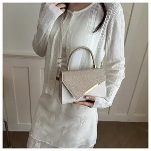 Detailed view of the stylish sequin handbag showcasing its elegant flap and gold metallic accent.