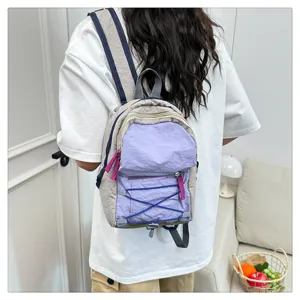 Casual mini backpack for women and students, stylish colorblock design with front zip pocket.