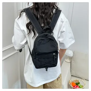Mini black backpack back view detail, showing casual style, shoulder straps and compact design.