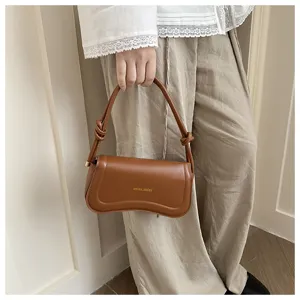 Brown PU leather underarm shoulder bag with knot handle detail, stylish commuting accessory.