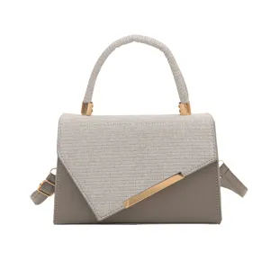 Chic grey sequin flap crossbody bag with elegant top handle and luxury gold hardware.