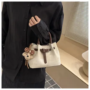 Stylish women bucket bag with cute bear pendant, casual top handle handbag for daily commuting.