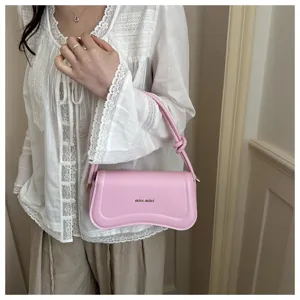 Pink PU leather underarm shoulder bag detail showing curved flap and chic strap.