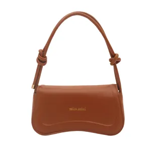 Brown leather shoulder bag for women, stylish curved underarm handbag with trendy knot design.