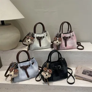 Stylish women shoulder crossbody bucket bag with cute bear charm and classic plaid design.