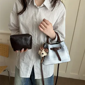 Trendy women bucket bag with matching pouch, chic plaid design and cute bear pendant.