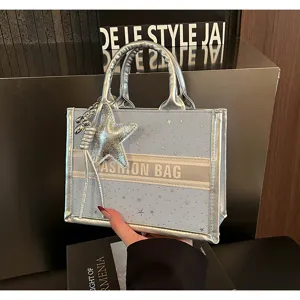 Light blue star tote bag with silver trim and star charm for stylish women daily use.