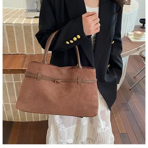 Detailed view of the brown suede commuter tote bag, featuring elegant belt buckle decoration.