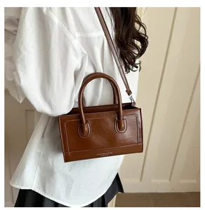 Detailed view of women vintage brown PU leather square crossbody bag, chic design for summer.