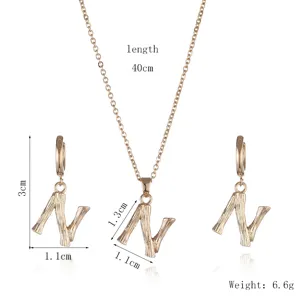 Gold initial N necklace and earrings jewelry set with unique branch texture design.