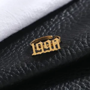 Detail shot of the gold stainless steel open ring featuring a custom 1990 Gothic number design.