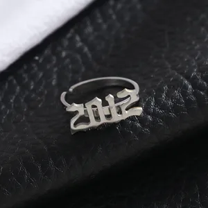 Detailed shot of stainless steel year number ring with gothic 2012 design on black leather.
