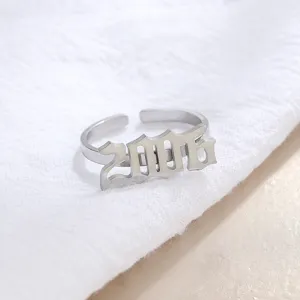 Stainless steel open ring detail shot featuring year 2006 in gothic font design.