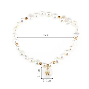 Freshwater pearl bracelet with letter W pendant, elegant minimalist fashion jewelry.