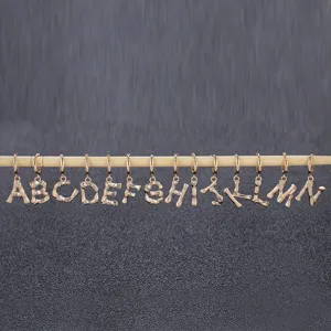 Gold tone alphabet letter charms pendant set, initial hanging decor for DIY jewelry making.