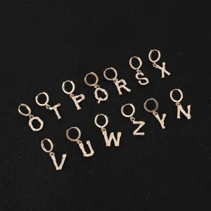 Detailed shot of stylish metallic letter earrings featuring unique branch texture in gold finish.