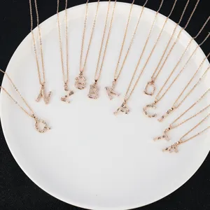Detailed view of rose gold letter necklaces set, elegant textured alphabet pendants for women.