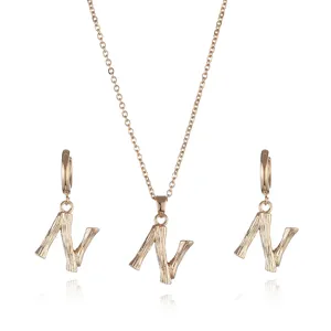 Gold letter N necklace and earrings set with unique textured pendant design for women.