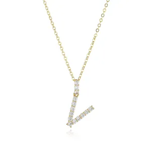 Gold-toned chain necklace featuring a sparkling pavé rhinestone letter pendant, delicate jewelry.